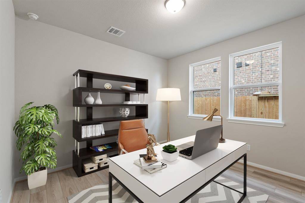 The home office features beautiful floors, large windows that give a fresh feel, this space promotes focus and creativity.