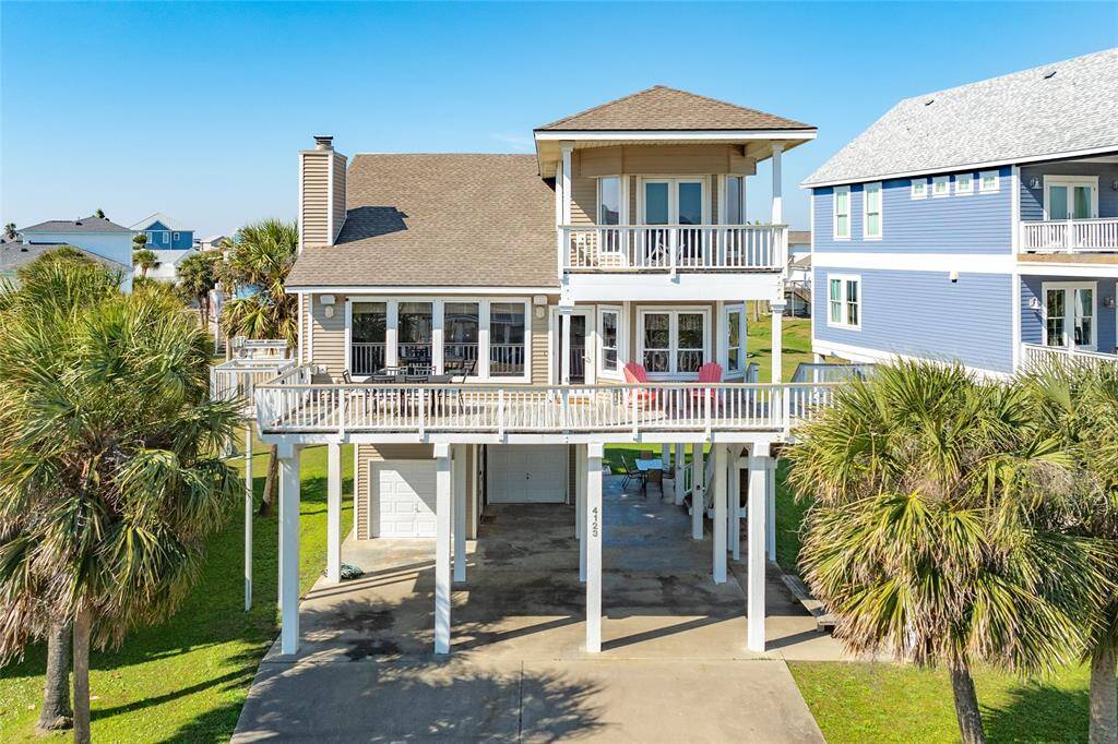Front of home with covered and uncovered deck. 1 car garage with golf cart garage. Golf cart included.