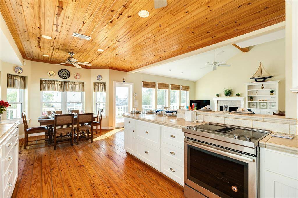 Flowing kitchen to living and dining with cathedral ceilings in living.  Wall to wall windows for natural light.  Beautiful wood floors.