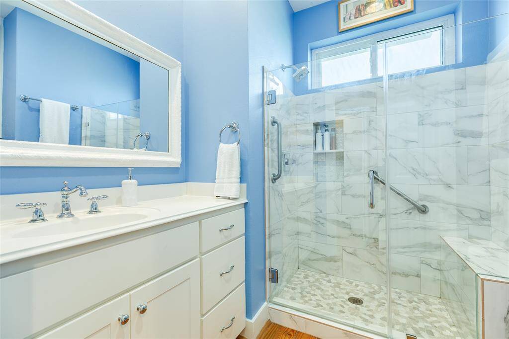 Updated Main level bathroom with large walk in shower and decorative tiles.