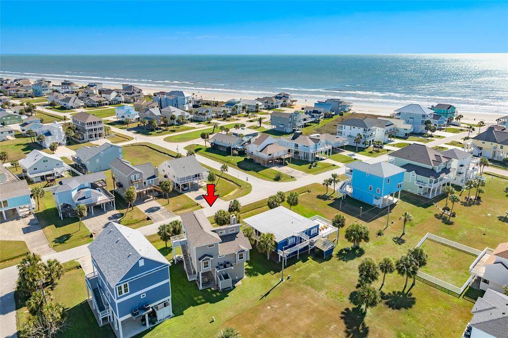 Aerial view showing location of home to the beach. Nice backyard green space.