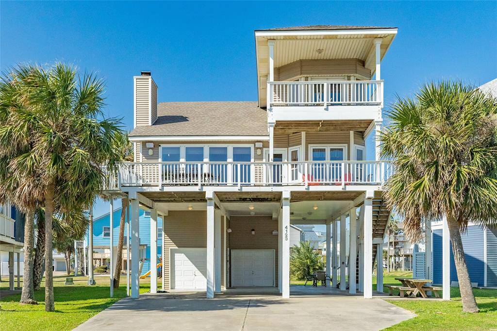 Ground view of home with one car garage and golf cart garage. Tons of room for entertaining.