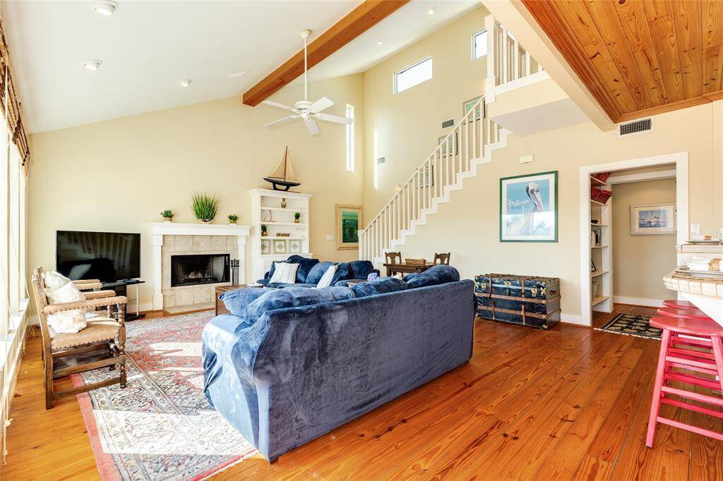 Inviting and cozy living space with cathedral ceilings,  Wood floors throughout home.
