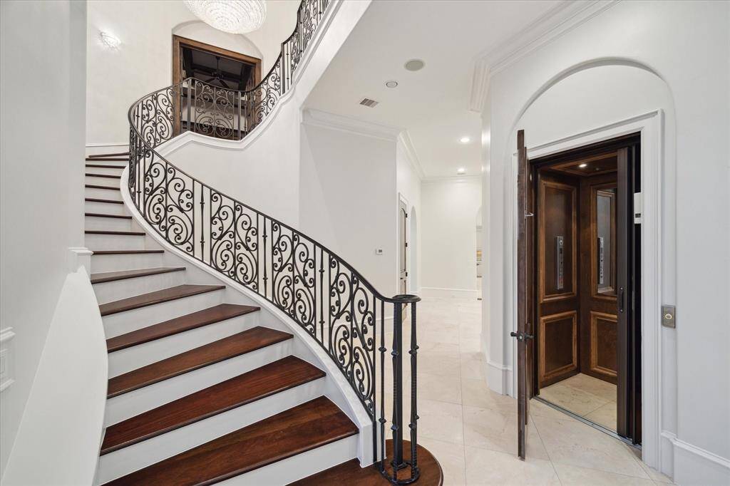 Formal entry with elegant staircase