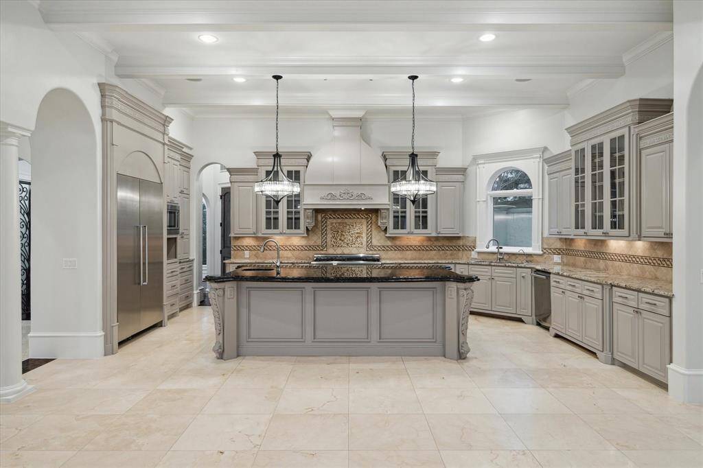 Chef's kitchen fully equipped with stainless steel appliances and ample cabinetry