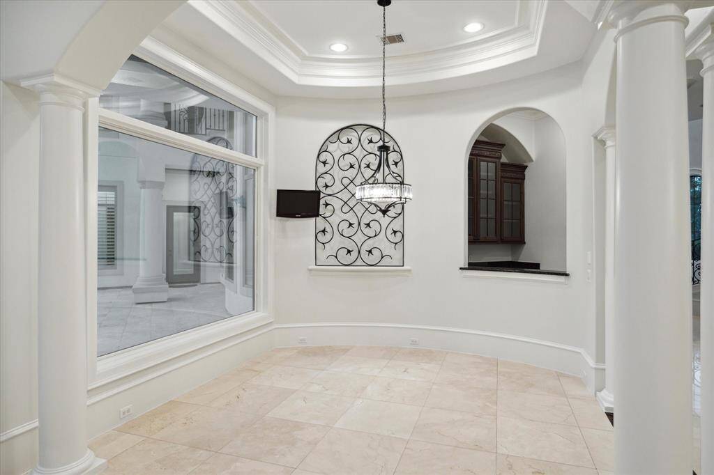Breakfast room with large bay window offering view of backyard