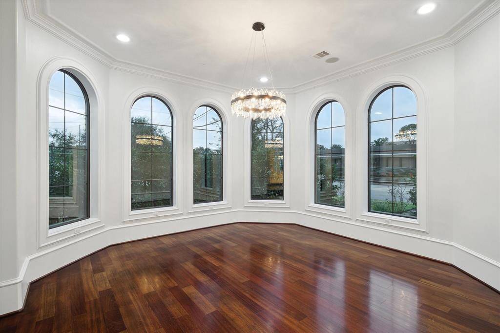 Wall of windows and chandelier in dining room