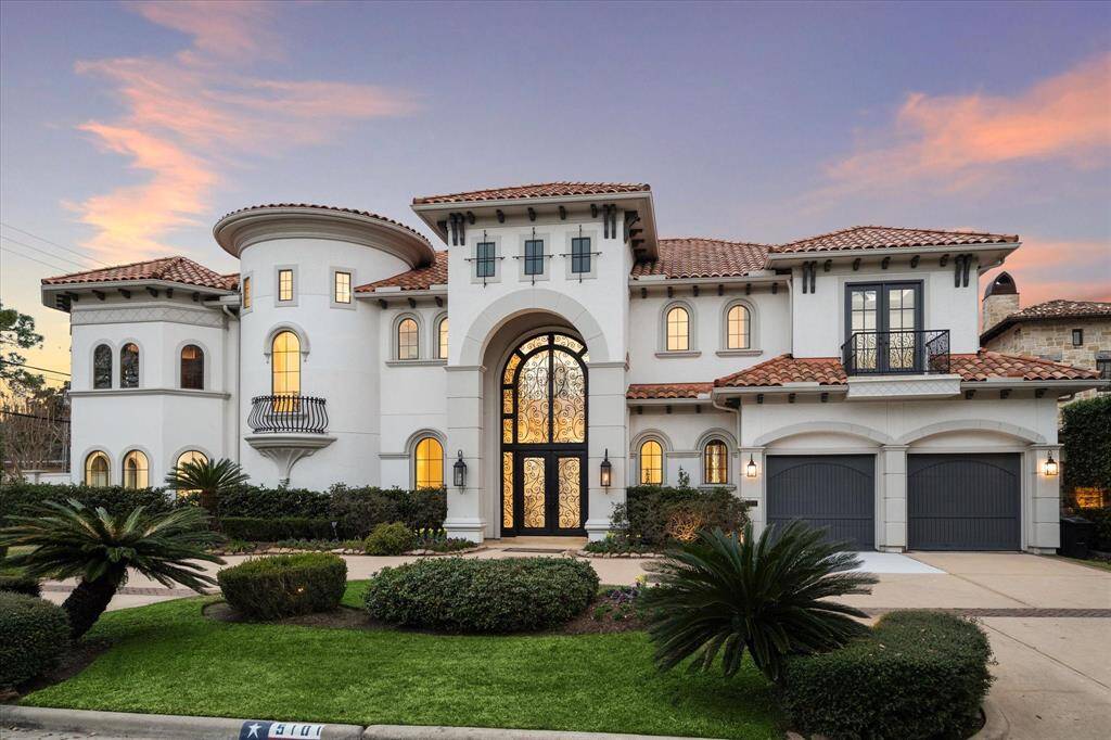Stately front elevation surrounded by manicured landscaping