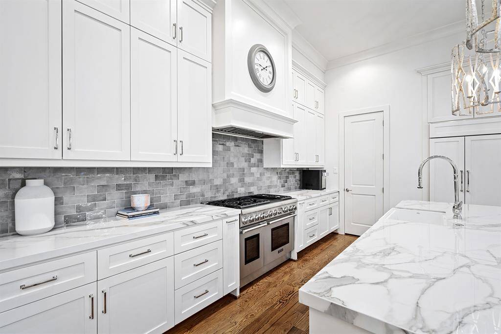 6 burner Thermador range with vent hood and griddle and double ovens. Thermador stainless dishwasher, walk-in pantry, 48" built-in SubZero fridge/freezer, and built-in Sharp microwave.