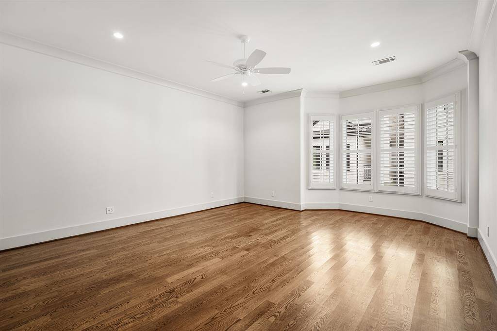 Secondary bedroom located on the second floor with sitting area extension, plantation shutters, walk-in closet, and ensuite bath.