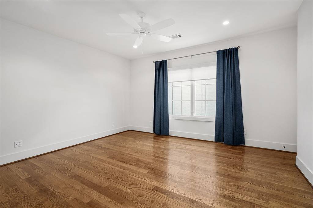 Third floor secondary bedroom with ensuite bath and walk-in closet.