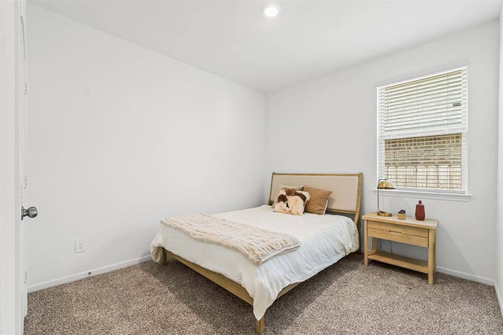 This additional secondary bedroom boasts generous closet space and plush carpeting, crating a cozy and practical environment.