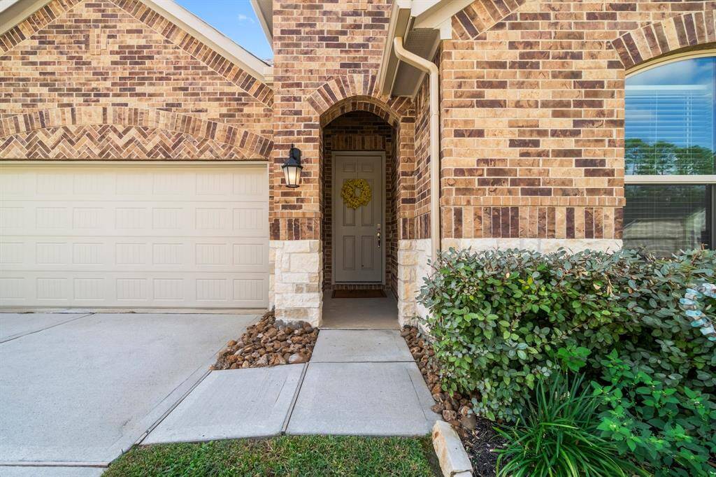 The 3-car tandem garage provides ample space, blending seamlessly with the home's design. Established landscaping enhances the curb appeal, crating a welcoming and well-maintained first impression.
