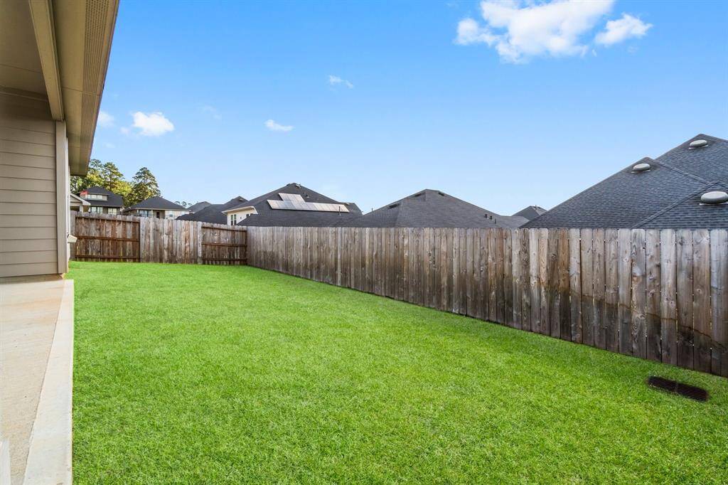 The backyard area offers ample outdoor space for activities and gatherings.