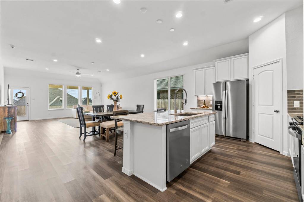 From the hallway, you are greeted with an open view of the kitchen, dining room, and living area, seamlessly connected to create a spacious and inviting flow, ideal for both daily living and entertaining.