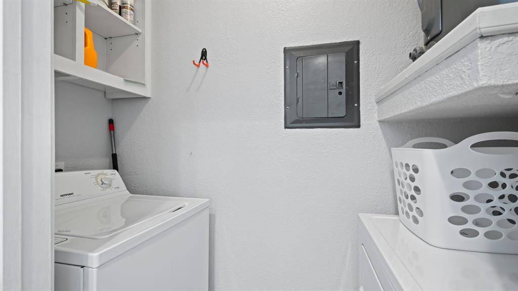 Laundry room conveniently located in back of kitchen.