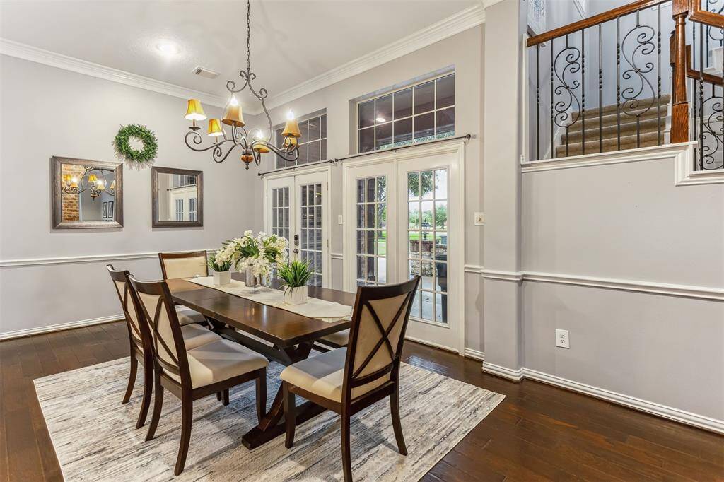 7014 Lake Haven Ct, Sugar Land Tx 77479-The dining area is framed by beautiful brick arches, adding character and a sense of history to the home. The rich wooden flooring extends throughout the space, creating a warm and inviting atmosphere. The transition from the dining area to the kitchen is smooth and visually appealing, with the kitchen's cabinetry and tile work complementing the overall design.