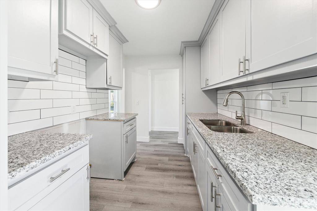 Granite counters and white subway tile add to the modern renovations. Plenty of counter space for cooking.