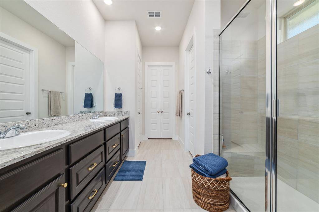 Primary bath features granite and stunning Kent Moore Grey Wolf cabinets