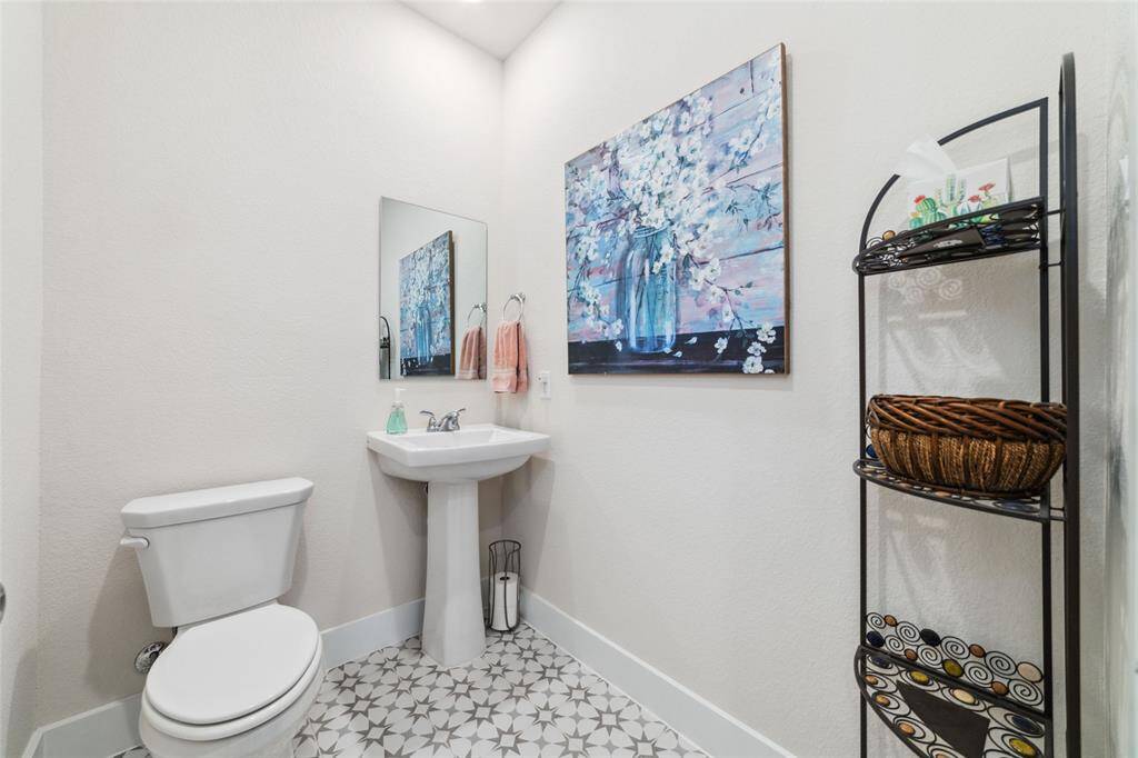 Oversized powder bath with upgraded Cosmo Grey designer tile