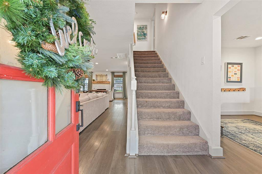 The red front door opens to reveal this completely renovated home with 2610 square feet of well-appointed living space. Flanking the foyer is an office on the right and the family room on the left.