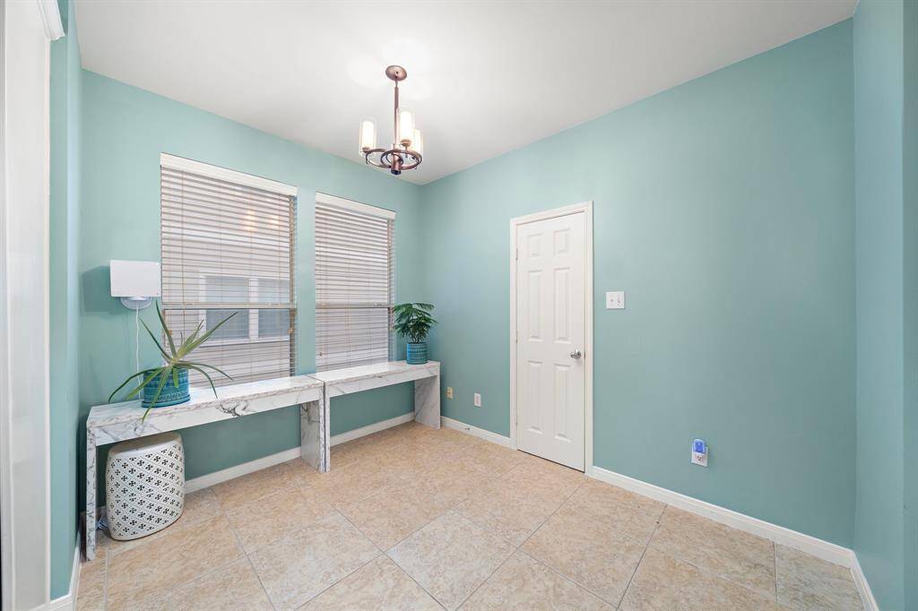 Breakfast area features travertine tile flooring and abundant natural light. Enjoy convenient proximity to the kitchen area.