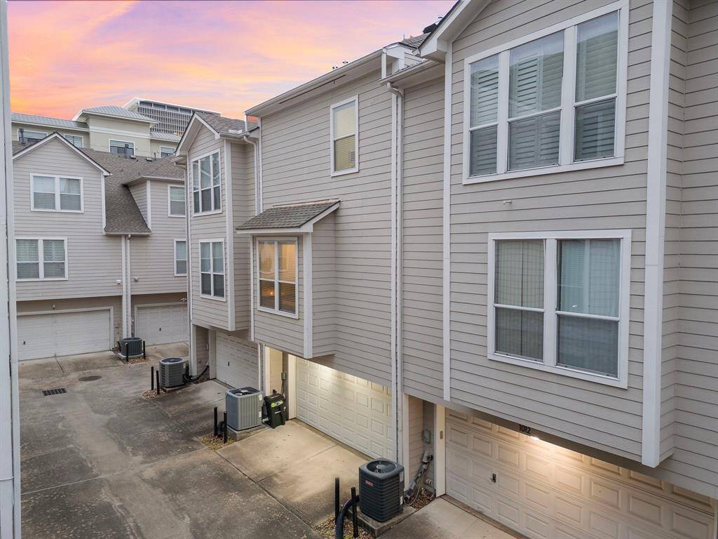 Multi-story townhomes offer private garages and a common drive offers access to each home, enhancing the community feel.