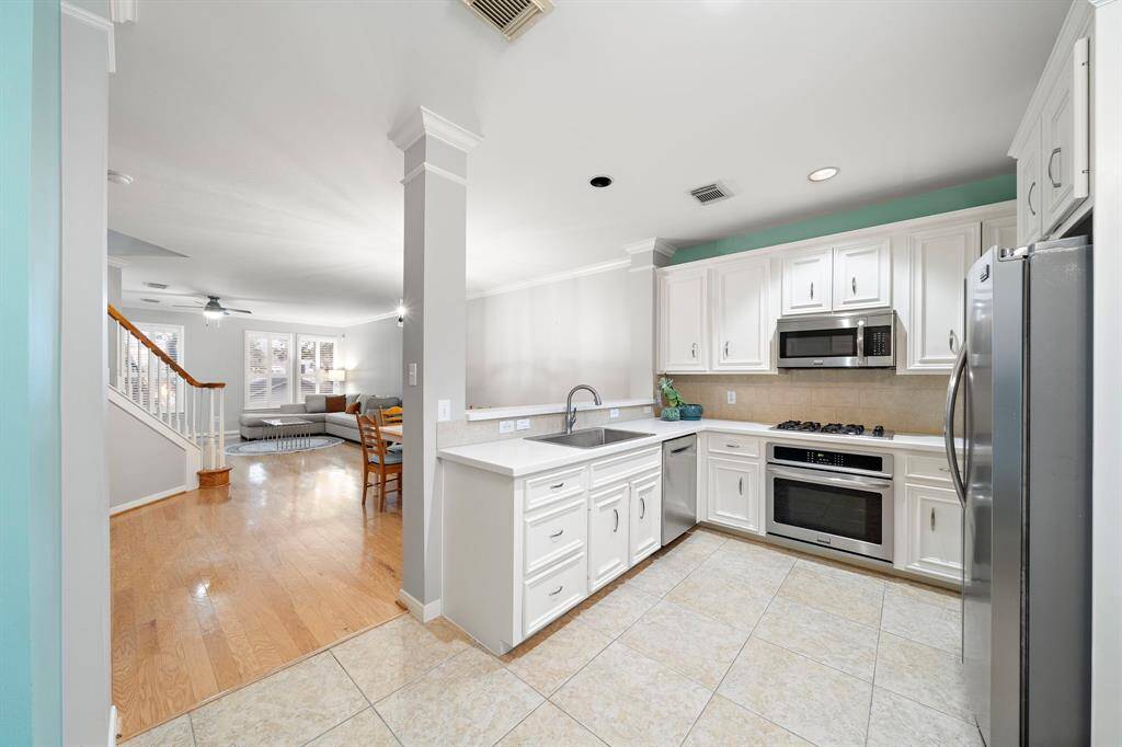 Well-equipped kitchen features stainless steel appliances and ample counter space, with convenient proximity to the breakfast nook.