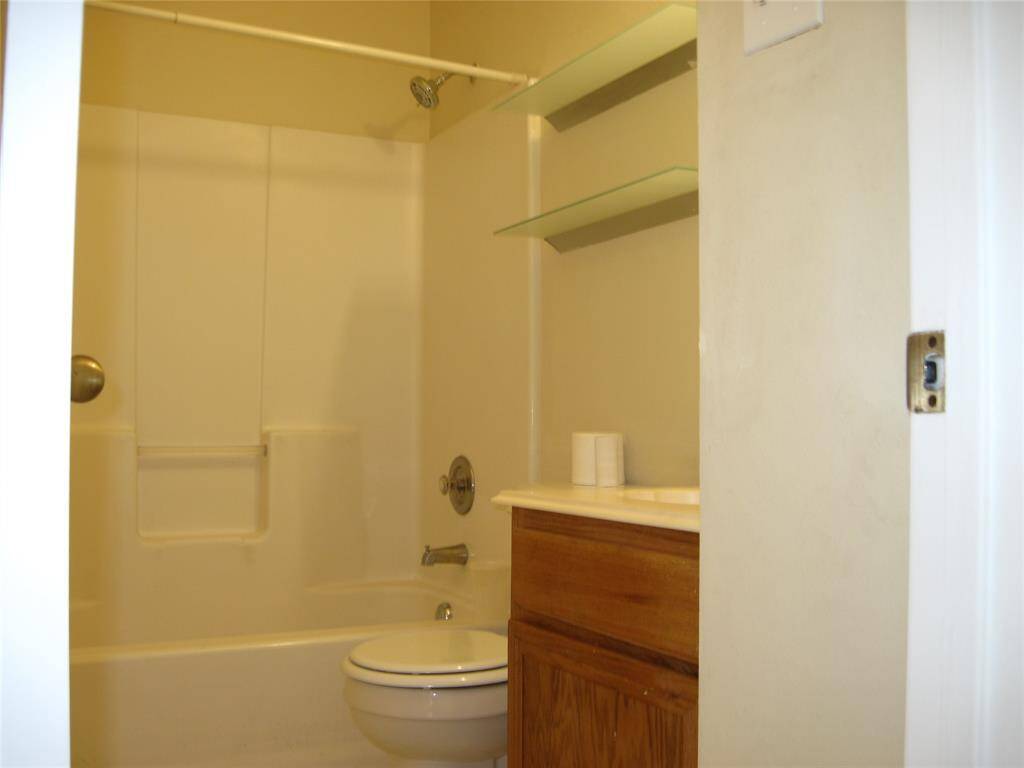 SECONDARY CONVENIENT BATHROOM VANITY, TUB AND SHOWER.
