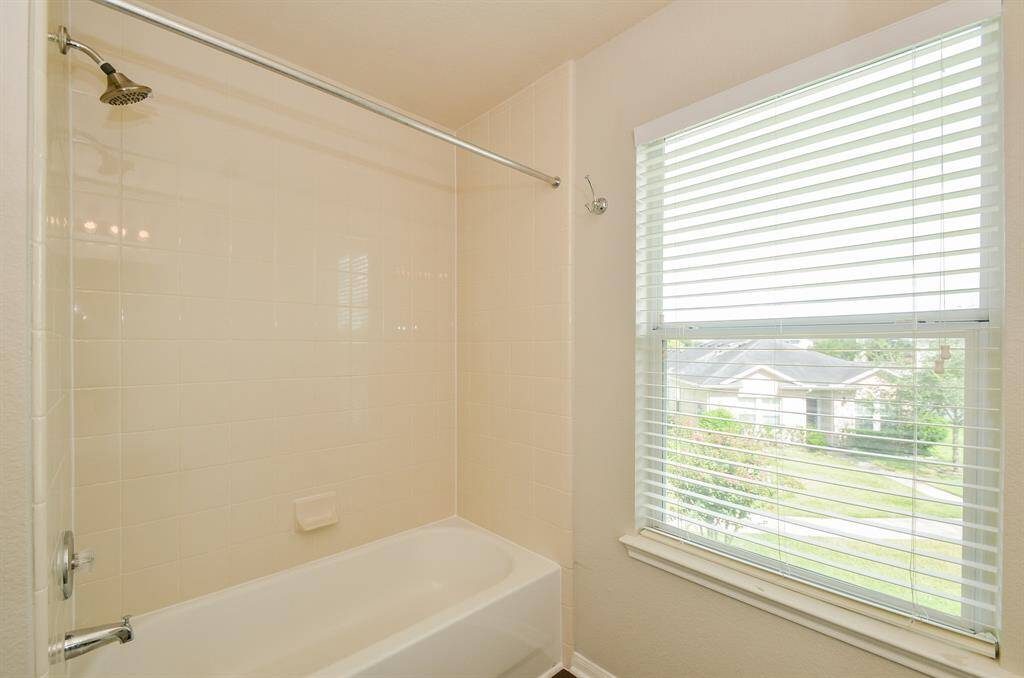 Escape into a soothing and relaxing bath tub with ceramic tile surround.