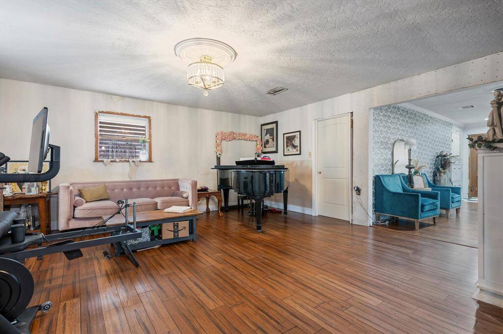 An inviting space off the kitchen offers versatility for a formal dining area or an additional living room.