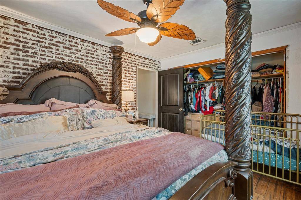 Charming front bedroom with a stylish faux brick accent wall.