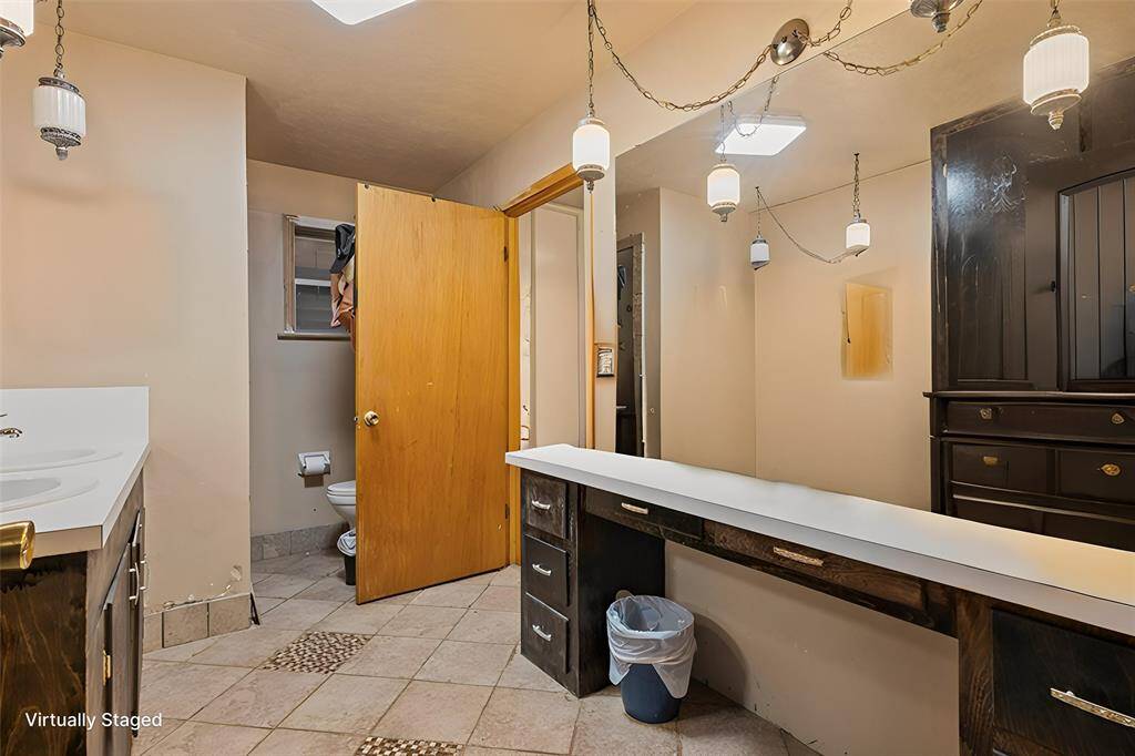 En suite bathroom #2 that is connected to laundry *virtually staged*