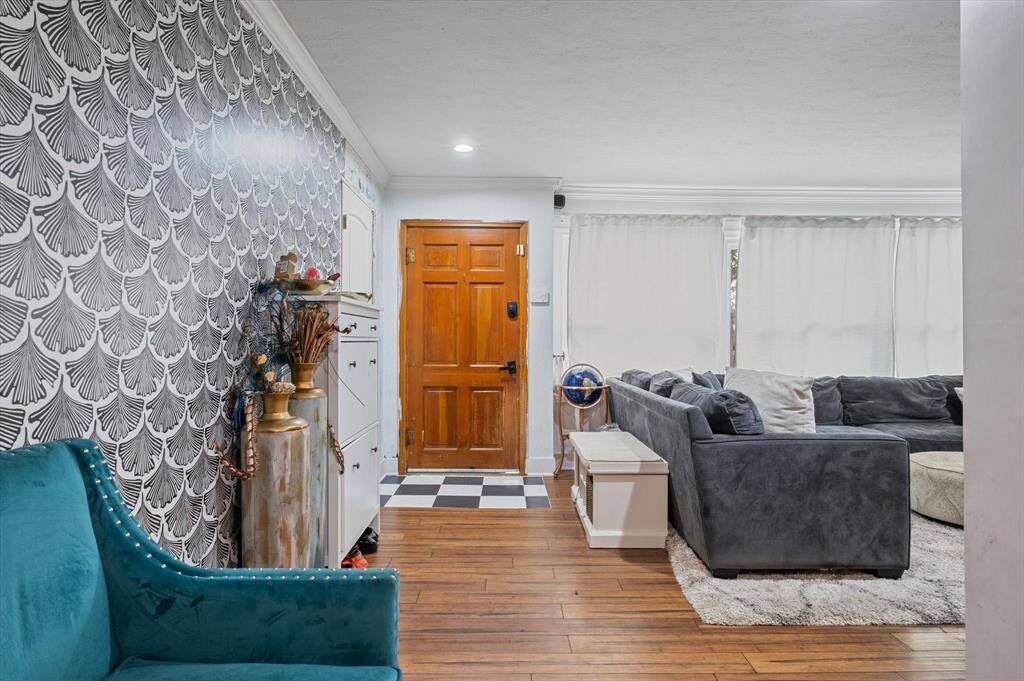 Welcome to a warm and inviting entryway featuring elegant wood flooring throughout.