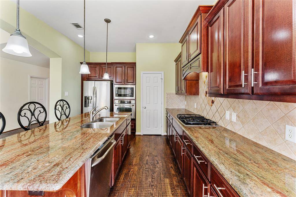 The kitchen is designed with abundant storage space, featuring spacious cabinets that offer plenty of room for organization and keeping everything within easy reach.