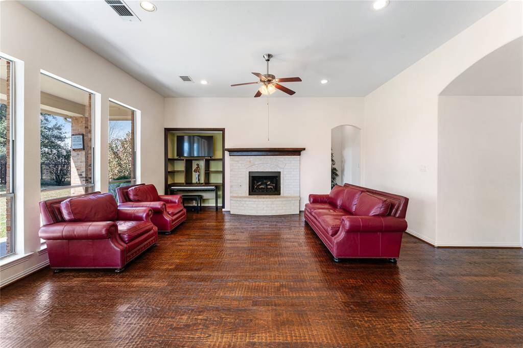 The spacious family room is the heart of the home, featuring a cozy gas-log fireplace with a charming brick surround, perfect for those cooler evenings. Built-in shelving offers both functionality and style, while an abundance of windows floods the space with natural light and provides stunning views of the serene lake just outside. This inviting room blends comfort with breathtaking scenery, making it ideal for both relaxing and entertaining.