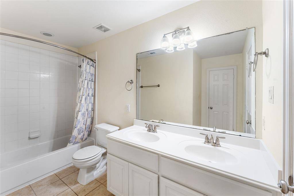 The secondary bathroom features dual sinks for added convenience, along with a tub/shower combo that offers both functionality and comfort for everyday use.
