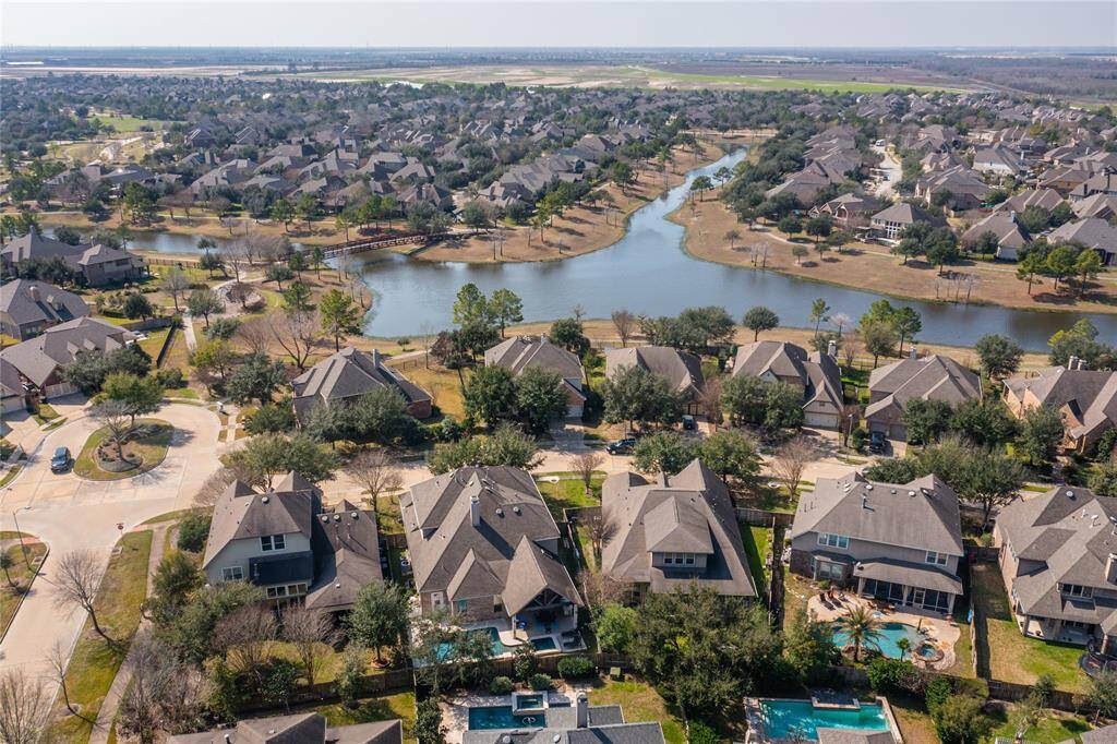 The aerial view highlights the stunning lake right in your backyard, offering a picturesque and tranquil setting that enhances the beauty of the home.