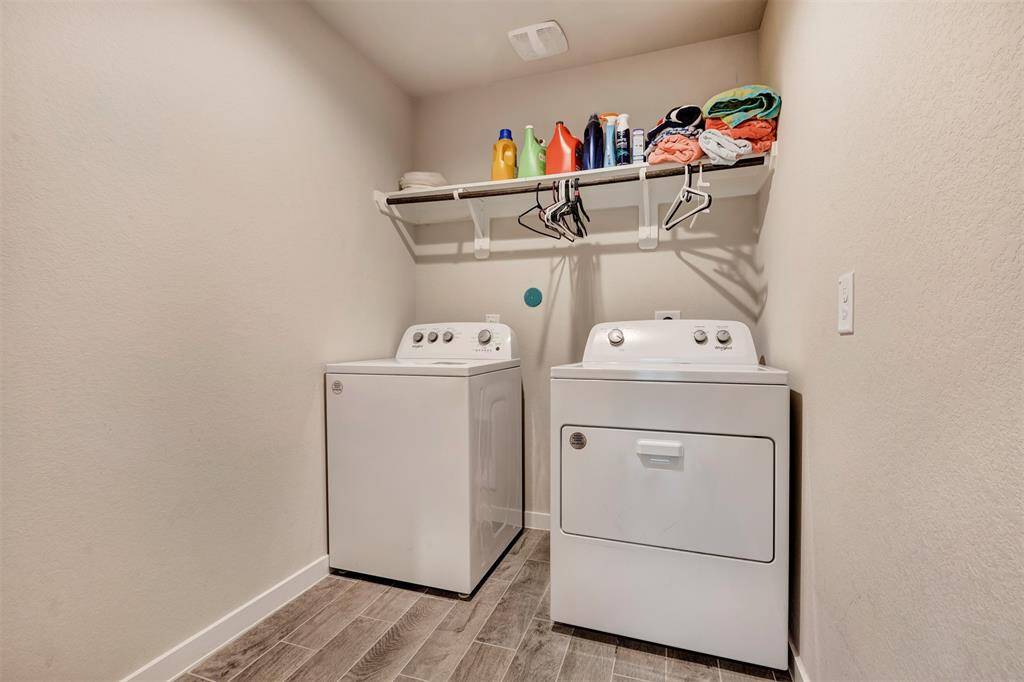 Convenient laundry room, designed for efficiency and easy storage.