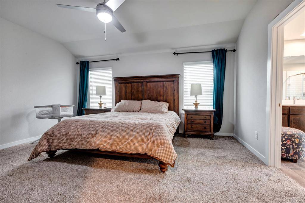 Cozy primary bedroom featuring soft carpeted floors