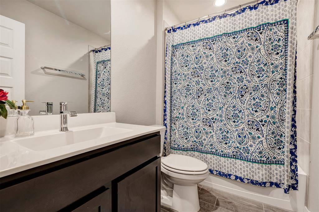 One of the secondary bathrooms, featuring a convenient tub and shower combo.