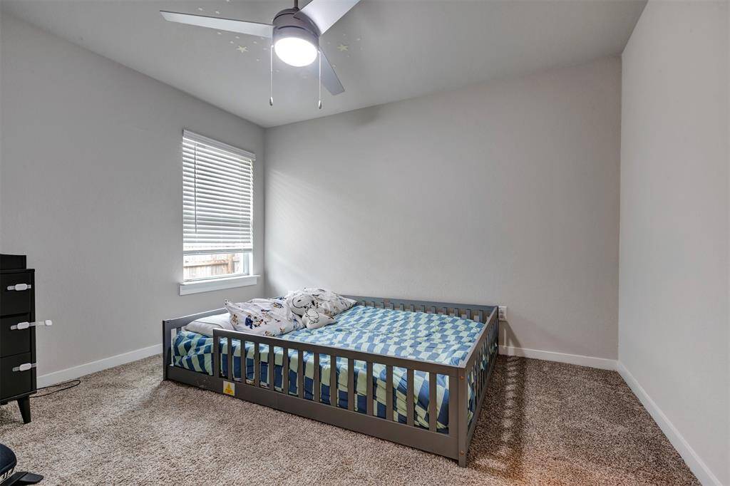 One of the secondary bedrooms, conveniently located beside the garage.