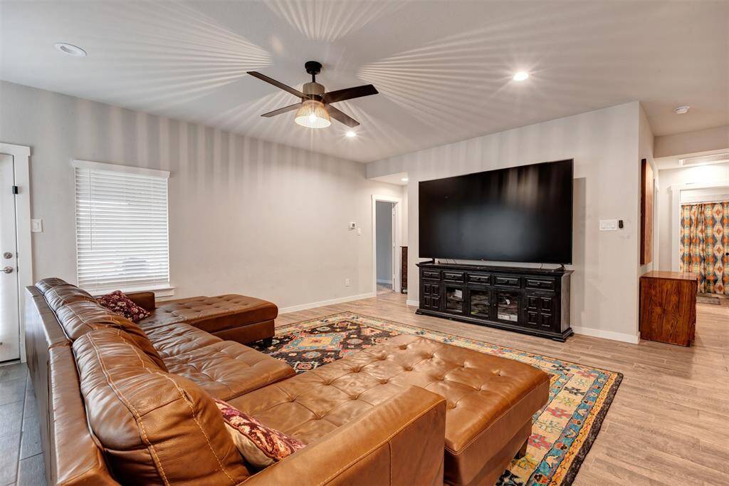 Another view of the living room, with the open door at the corner, leading to the main bedroom.