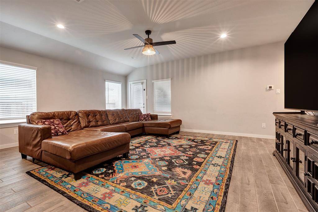 The bright and airy spacious living room, surrounded by expansive glass windows that let in plenty of natural light.