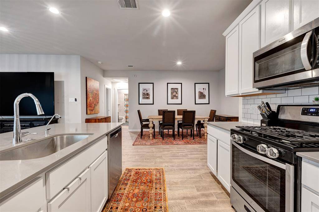 This fully equipped kitchen has sleek stainless steel appliances, perfect for all your culinary needs.