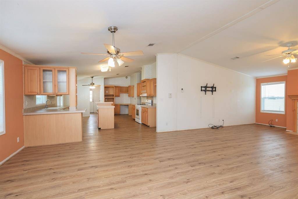 Living room opens to Kitchen