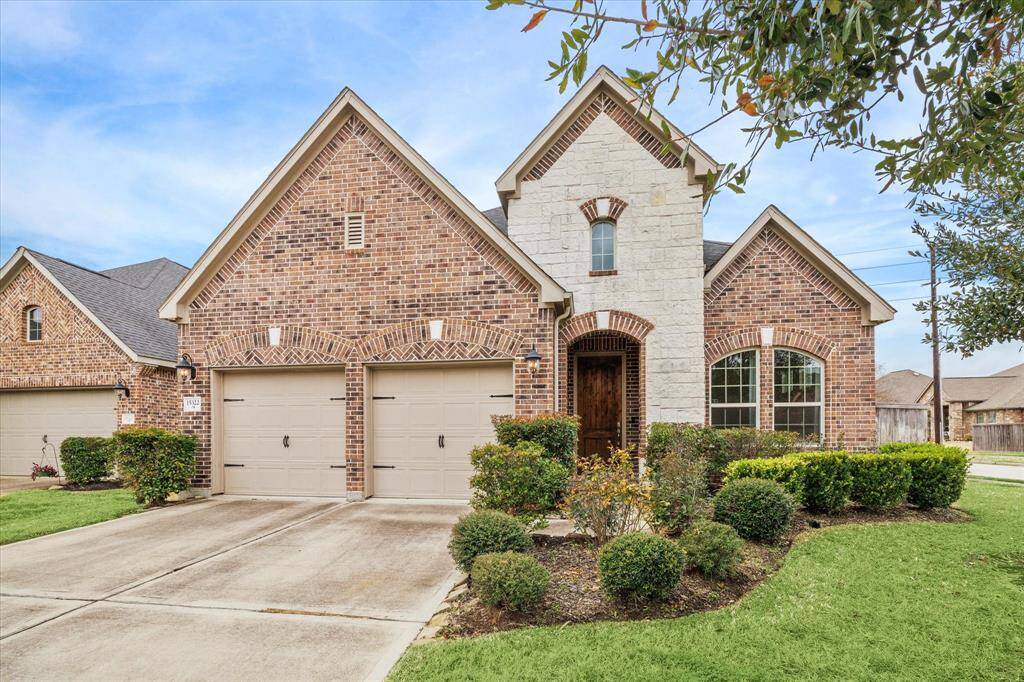 This charming brick home with charming curb appeal on a corner lot offers a double wide driveway, a beautifully landscaped front yard, and a welcoming arched entryway.