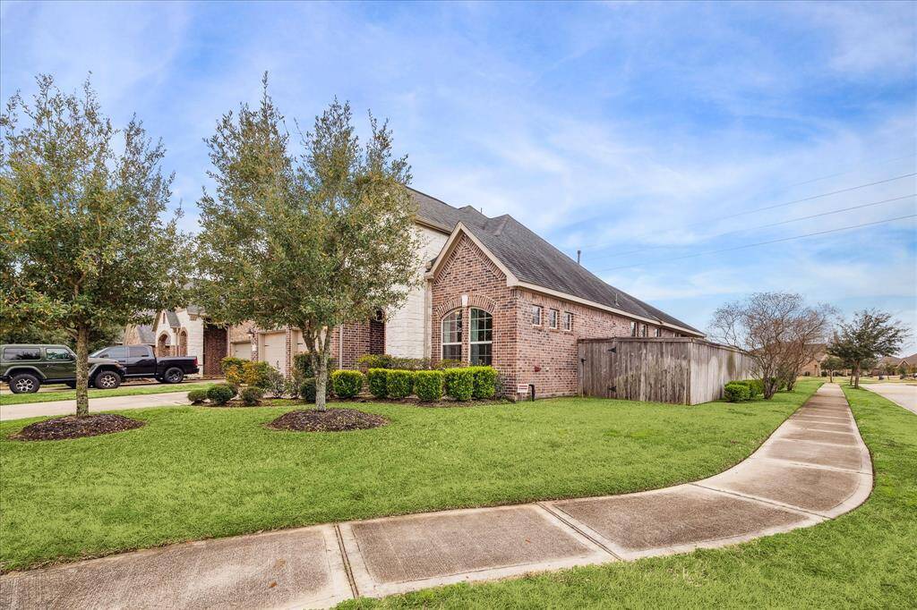 This house has a classic design and a large side yard, offering ample outdoor space.