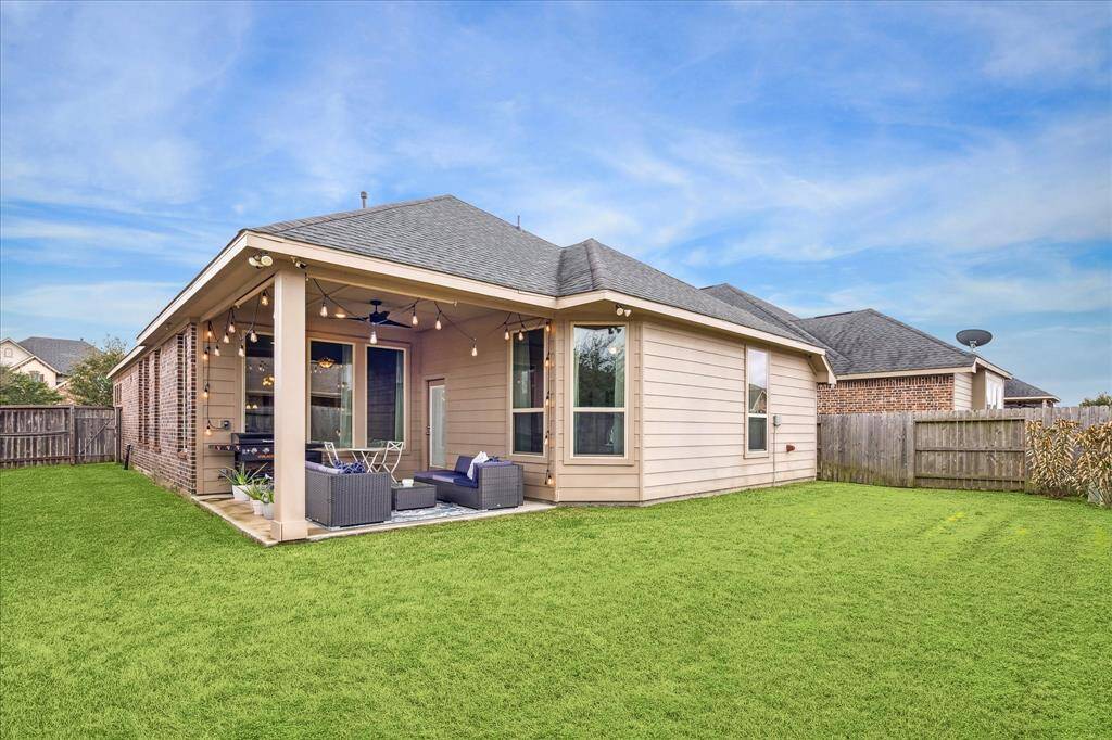 The covered patio is perfect for outdoor relaxation and entertaining. It has an added outdoor gas line. The exterior has a combination of brick and siding, complemented by a well-maintained lawn and privacy fence.