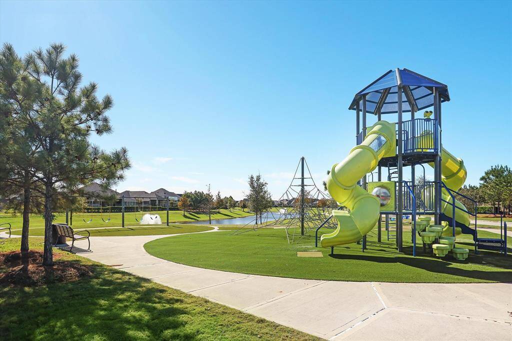 Hayden Lakes offers a community park with playground including slides and climbing structures, surrounded by walking paths and greenery. Ideal for families and outdoor activities.